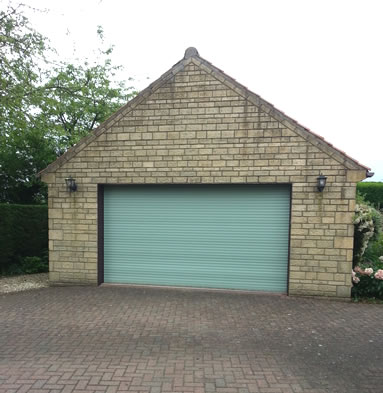 A roller garage door in chartwell green